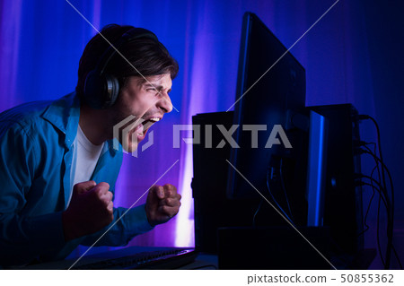 Professional Gamer Playing and Winning in Shooter Online Video Game Professional Gamer Playing and Winning in Shooter Online Video Game 50855362