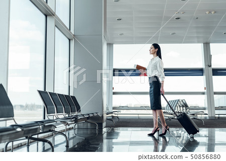 Excited young woman is travelling by air 50856880