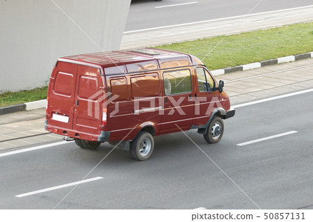Red minibus in the city rear view Red minibus in the city rear view 50857131