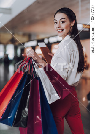 Jolly woman is flying on holiday after shopping 50857232