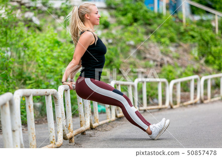 Fitness lifestyle. Young woman doing push ups Fitness lifestyle. Young woman doing push ups 50857478