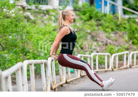 Fitness lifestyle. Young woman doing push ups 50857479
