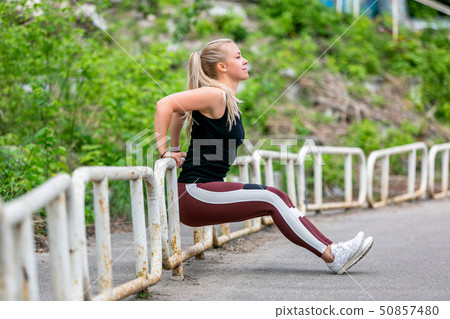 Fitness lifestyle. Young woman doing push ups 50857480