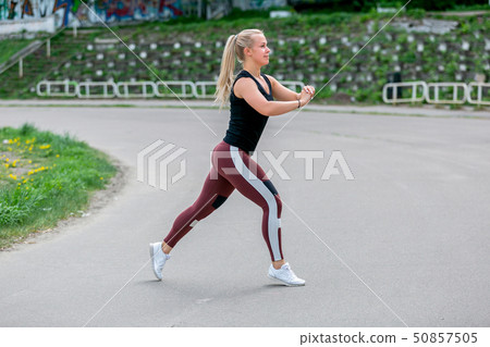 Fitness lifestyle. Young woman doing lunges 50857505
