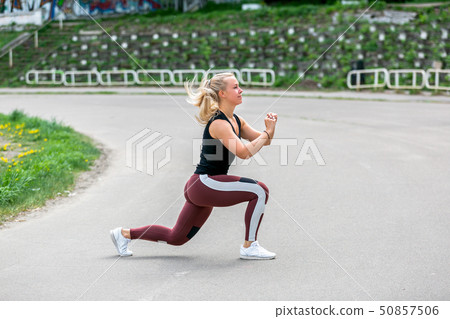 Fitness lifestyle. Young woman doing lunges Fitness lifestyle. Young woman doing lunges 50857506