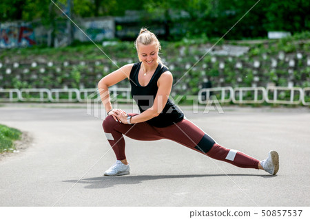 Fitness lifestyle. Young woman warming up 50857537