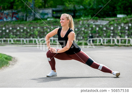 Fitness lifestyle. Young woman warming up Fitness lifestyle. Young woman warming up 50857538
