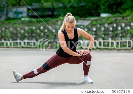 Fitness lifestyle. Young woman warming up 50857539