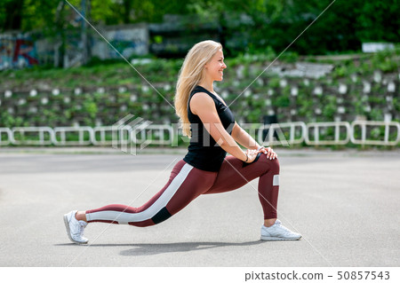 Fitness lifestyle. Young woman doing lunges 50857543