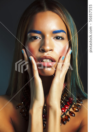 young pretty modern african american girl with bright fashion makeup and ethnic jewelry closeup 50857555