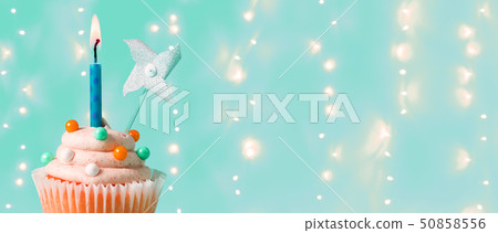 Cupcake with a lit candle Cupcake with a lit candle 50858556