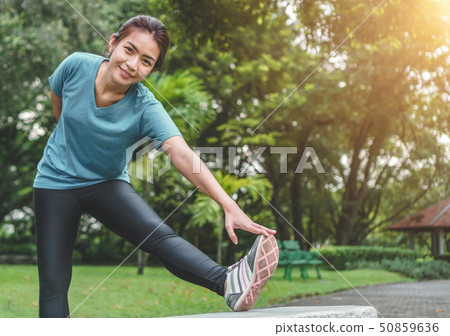 Young asian woman runner stretching arm and leg Young asian woman runner stretching arm and leg 50859636