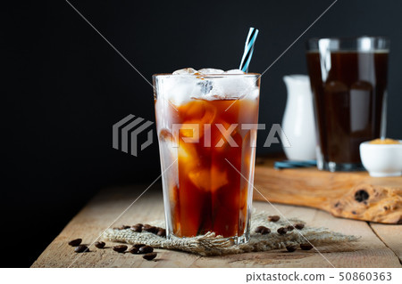 Ice coffee in a tall glass with cream. 50860363
