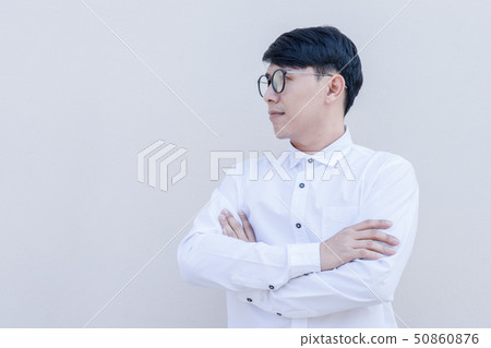Side portrait of asian guy in white shirt on wall Side portrait of asian guy in white shirt on wall 50860876