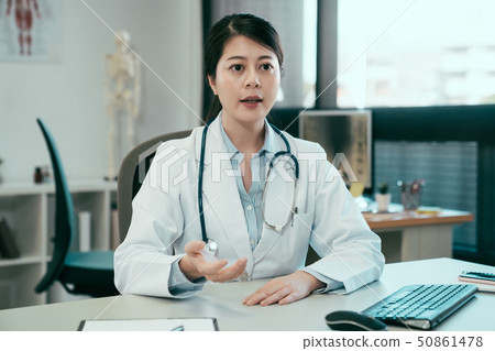 doctor in clinic office consulting with patient doctor in clinic office consulting with patient 50861478