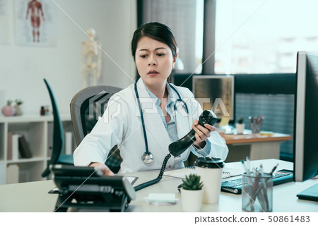 nurse having problem telephone contact colleague. 50861483