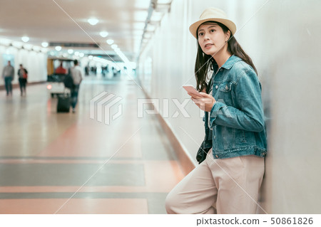 joyful girlfriend leaning on wall waiting joyful girlfriend leaning on wall waiting 50861826