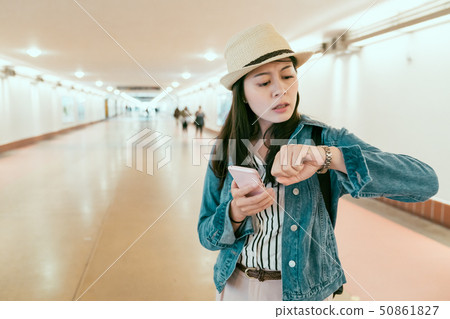 female tourist commuter check time worried late 50861827
