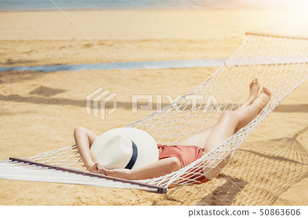 Asian women relaxing in hammock summer holiday on 50863606
