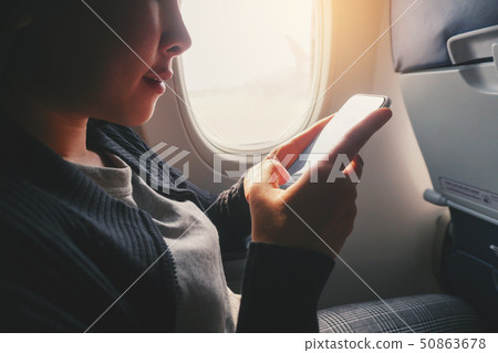 Tourist Asian woman sitting near airplane window 50863678