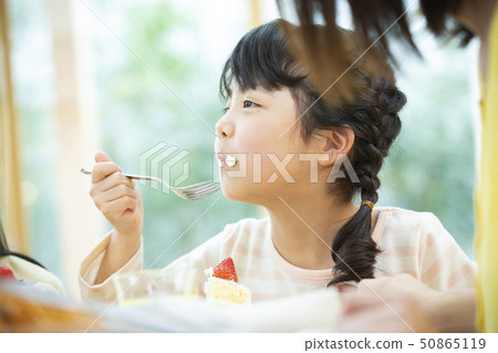 A girl who eats a cake A girl who eats a cake 50865119