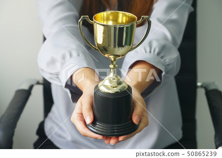 Business woman give trophy,win concept. 50865239