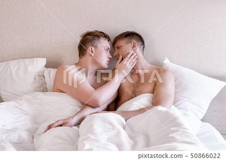 Handsome gay men couple on bed together. Love and Handsome gay men couple on bed together. Love and 50866022