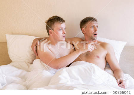 Handsome gay men couple on bed together. Love and Handsome gay men couple on bed together. Love and 50866041