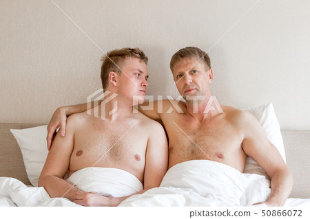 Handsome gay men couple on bed together. Love and Handsome gay men couple on bed together. Love and 50866072