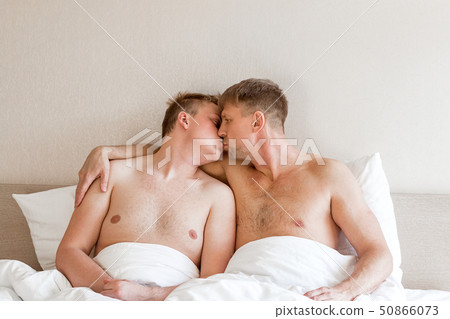 Handsome gay men couple on bed together. Love and Handsome gay men couple on bed together. Love and 50866073