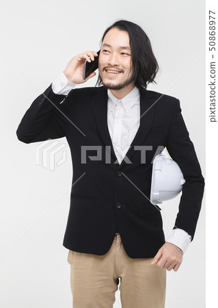 Young Asian engineer use cellphone.. 50868977