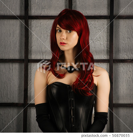 Portrait of Red-haired girl in a leather corset 50870035