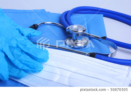 Medical stethoscope lying on a blue doctor's form and notepad close-up. the therapist's work space. 50870305