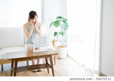 Woman checking skin with mirror 50870512