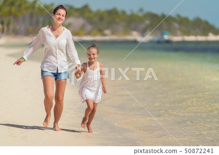 Young mother and little daughter enjoying the beach in Dominican Republic Young mother and little daughter enjoying the beach in Dominican Republic 50872241