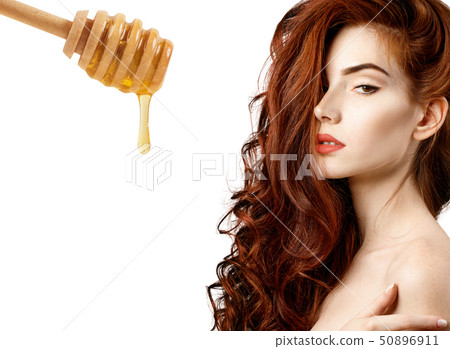 Woman with honey spoon prepare for hair mask. Woman with honey spoon prepare for hair mask. 50896911