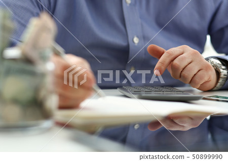 Male hand using calculator counting financial expenses Male hand using calculator counting financial expenses 50899990