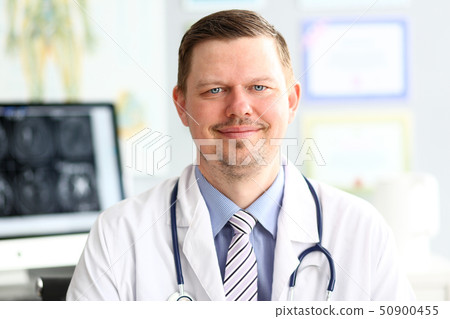 Adult smiling gp looking in camera in office Adult smiling gp looking in camera in office 50900455