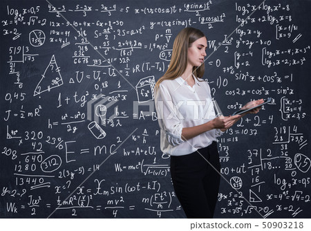 Beautiful woman thinking how to solve a math problem Beautiful woman thinking how to solve a math problem 50903218
