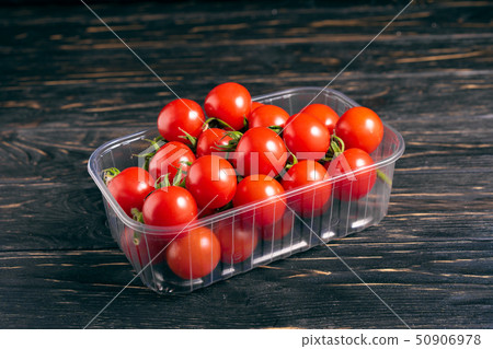 Cherry tomatoes in the plastic box on the wooden Cherry tomatoes in the plastic box on the wooden 50906978