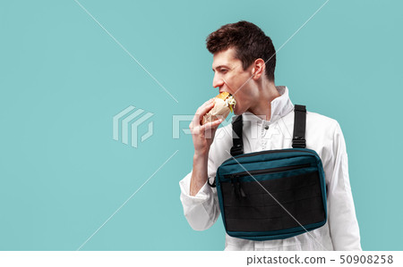 Young stylish male worker with chest rig bag is Young stylish male worker with chest rig bag is 50908258