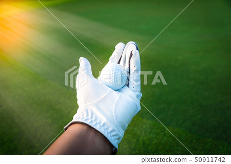 Close up golf ball in golf glove hand Close up golf ball in golf glove hand 50911742