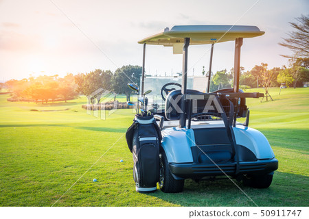 A Golf cart parking on green grass 50911747