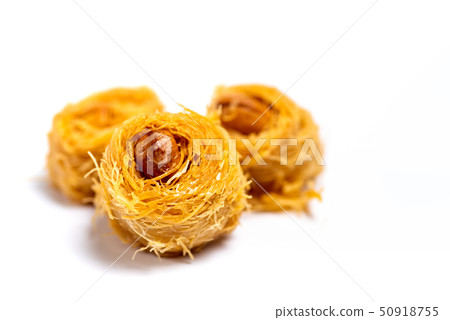 Arabic kadayif dessert with cashew nuts isolated Arabic kadayif dessert with cashew nuts isolated 50918755