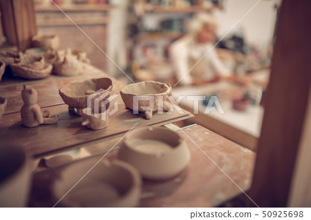 Close up of clay bowls standing on the shelf 50925698