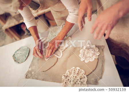 Top view of crocheted napkins in female hands 50932139