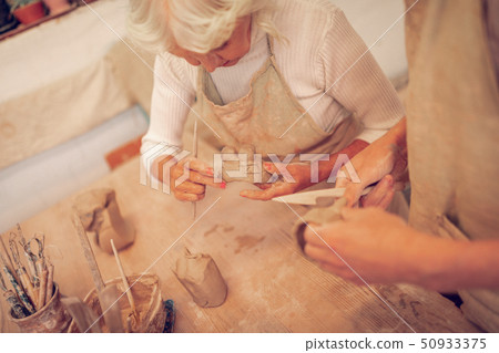 Top view of a positive senior woman looking at the bowl Top view of a positive senior woman looking at the bowl 50933375