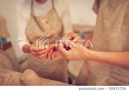 Selective focus of metallic wire in male hands Selective focus of metallic wire in male hands 50935726