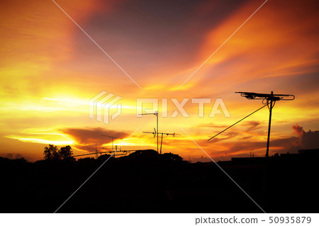 Silhouette of sunset with television antenna Silhouette of sunset with television antenna 50935879