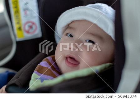 Baby sitting on a child seat Baby sitting on a child seat 50943374